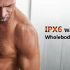 A muscular man is using an electric trimmer on his chest, demonstrating the waterproof and washable design of a grooming set.