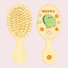 A pair of light yellow cartoon mini air cushion massage combs with a happy face design.