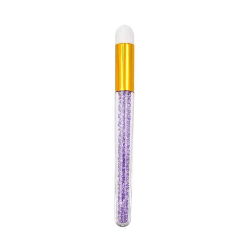 Eyelash extension cleaning bottle with a gold cap and a clear tube filled with purple lash extensions.
