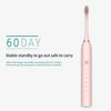 A pink sonic electric toothbrush with a charging base and brush head, promoting a 60-day standby use.