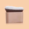 A pro-grade contour foundation brush with angled wavy bristles in a beige handle and brown/white bristles.