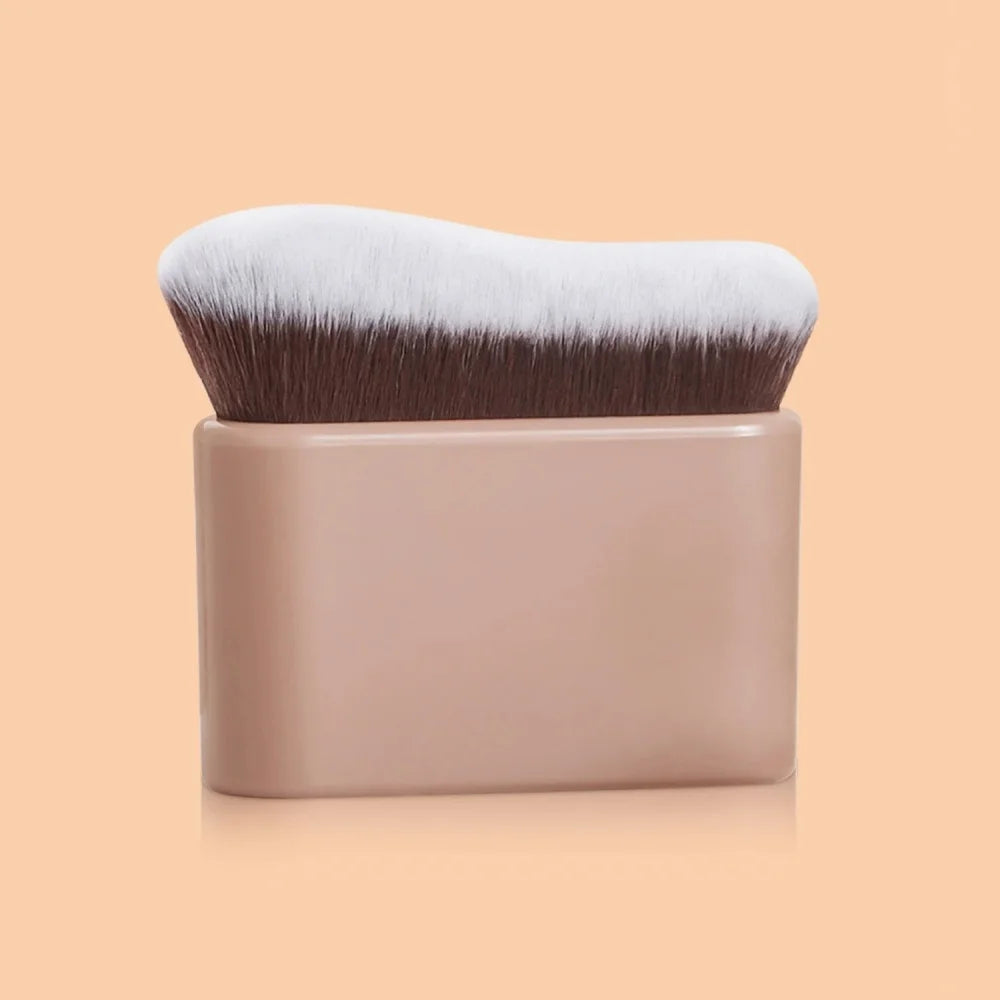A pro-grade contour foundation brush with angled wavy bristles in a beige handle and brown/white bristles.