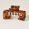 A set of brown and black leopard print non-slip hat claw clips with a matte finish.