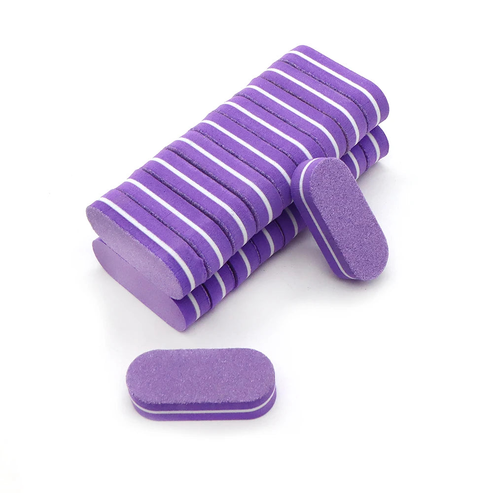 A pack of purple dual-grit nail buffing blocks, some stacked and one lying separately.