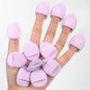 A hand holds a set of pink latex-free finger puffs for makeup application.