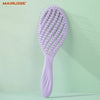 A purple hollow-out detangling hair brush with scalp massage bristles is shown against a light green background.