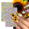 A hand displays fingernails decorated with colorful flower and butterfly nail stickers for DIY decoration.