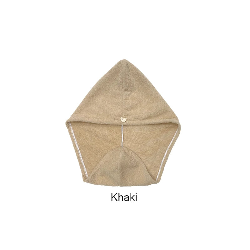 A beige microfiber hair towel wrap with a gathered top and a wide bottom edge.
