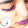 Close-up of an eye featuring purple and gold eyelash clusters and a gold lip accent.