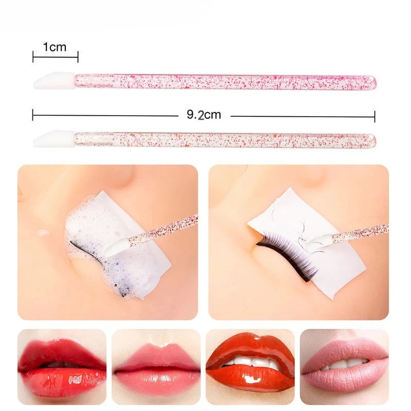 A set of disposable eyelash and eyebrow brushes shown with various shades of pink and red, demonstrating their size and appli