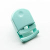 A light mint green mini folding eyelash curler set shown from above.