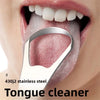 A close-up of a person's mouth showing a stainless steel tongue cleaner being used to scrape the tongue.