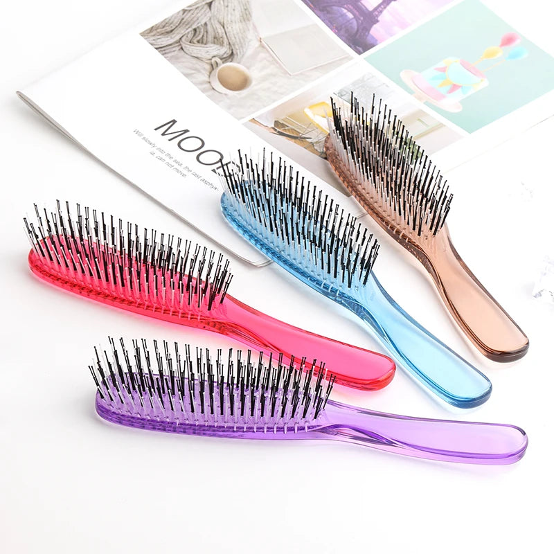 A collection of various colored scalp massage combs for hair detangling displayed on a white background.