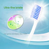 A white toothbrush with ultra-fine bristles is shown next to a magnified view of teeth and a green cleaning substance.