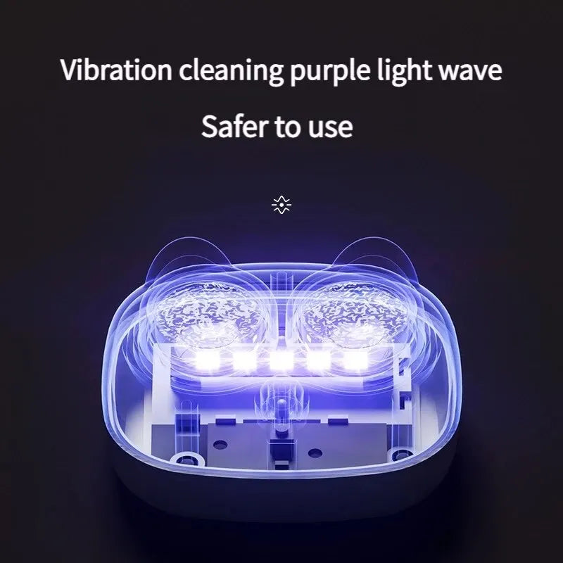 A clear plastic case containing a light source and vibrating elements for cleaning contact lenses.