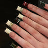 Press-on nails featuring a French wave design with blue and brown accents and gold glitter details on fingers