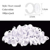 A pile of white disposable glue rings for eyelash extensions and nail art
