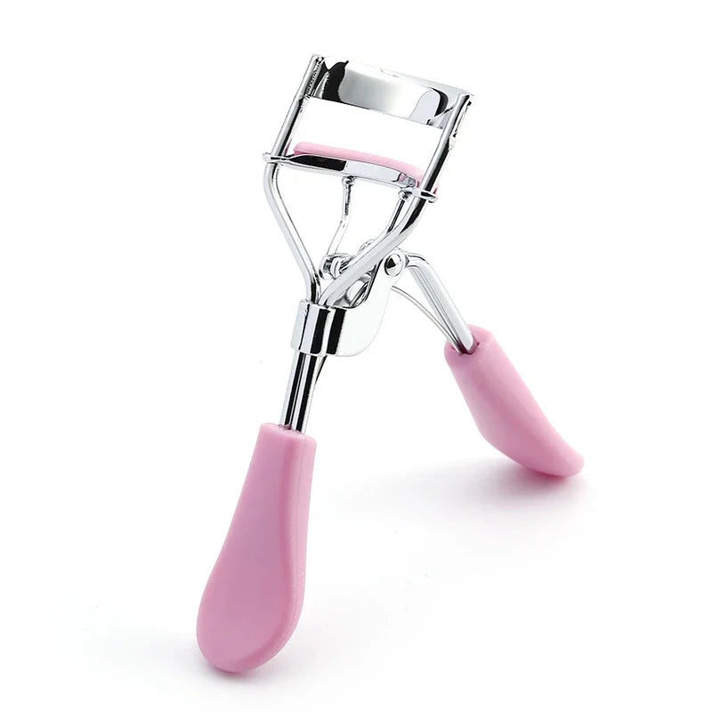 A silver eyelash curler with pink silicone grips shown against a white background.