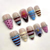 A collection of 24 press-on nails featuring pink flowers and striped nail designs in various colors.