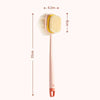 A pink long-handle loofah back scrubber with a yellow mesh sponge shown against a white background.