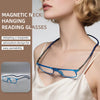 A woman is wearing magnetic neck hanging reading glasses with blue frames against a light background.