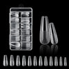 A collection of frosted French false nails in various shapes and lengths displayed on a black background.