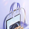 A purple portable and compact body hair remover device with a clear case and gold-colored tools.