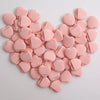 A cluster of pink latex-free finger puffs shaped like hearts, used for makeup application.