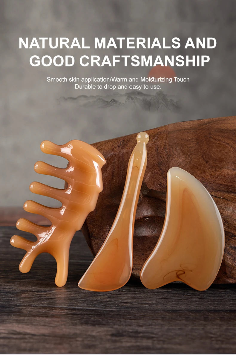 A set of natural materials facial massage tools in a light orange color displayed on a wooden surface.