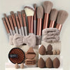 A collection of professional makeup brushes and sponges in various shades of brown and beige.