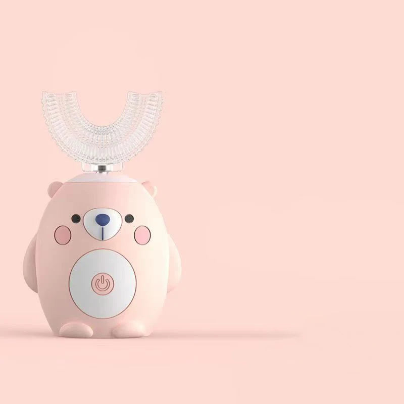 A pink electric toothbrush shaped like a bear with a clear silicone brush head against a light background.