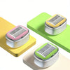 A precision manual safety razor in pink, green, and beige colors displayed on a light wooden surface.