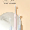 A pink and blue sonic electric toothbrush is shown next to its brush head, illustrating standard and gentle cleaning modes.