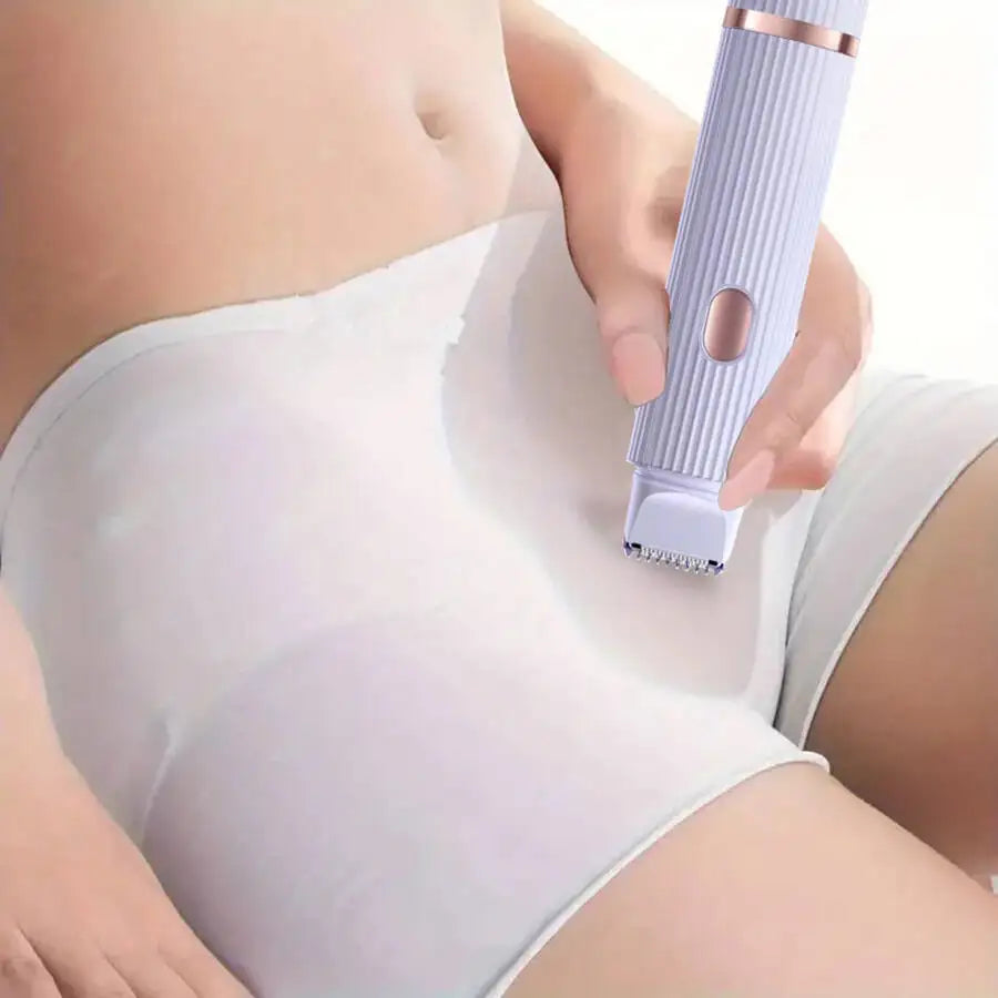 A hand is using a white portable dual-head electric shaver on the inner thigh area of a person's leg.