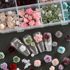A collection of 3D floral butterfly pearl nail art charms in various shades of pink, green, and red.