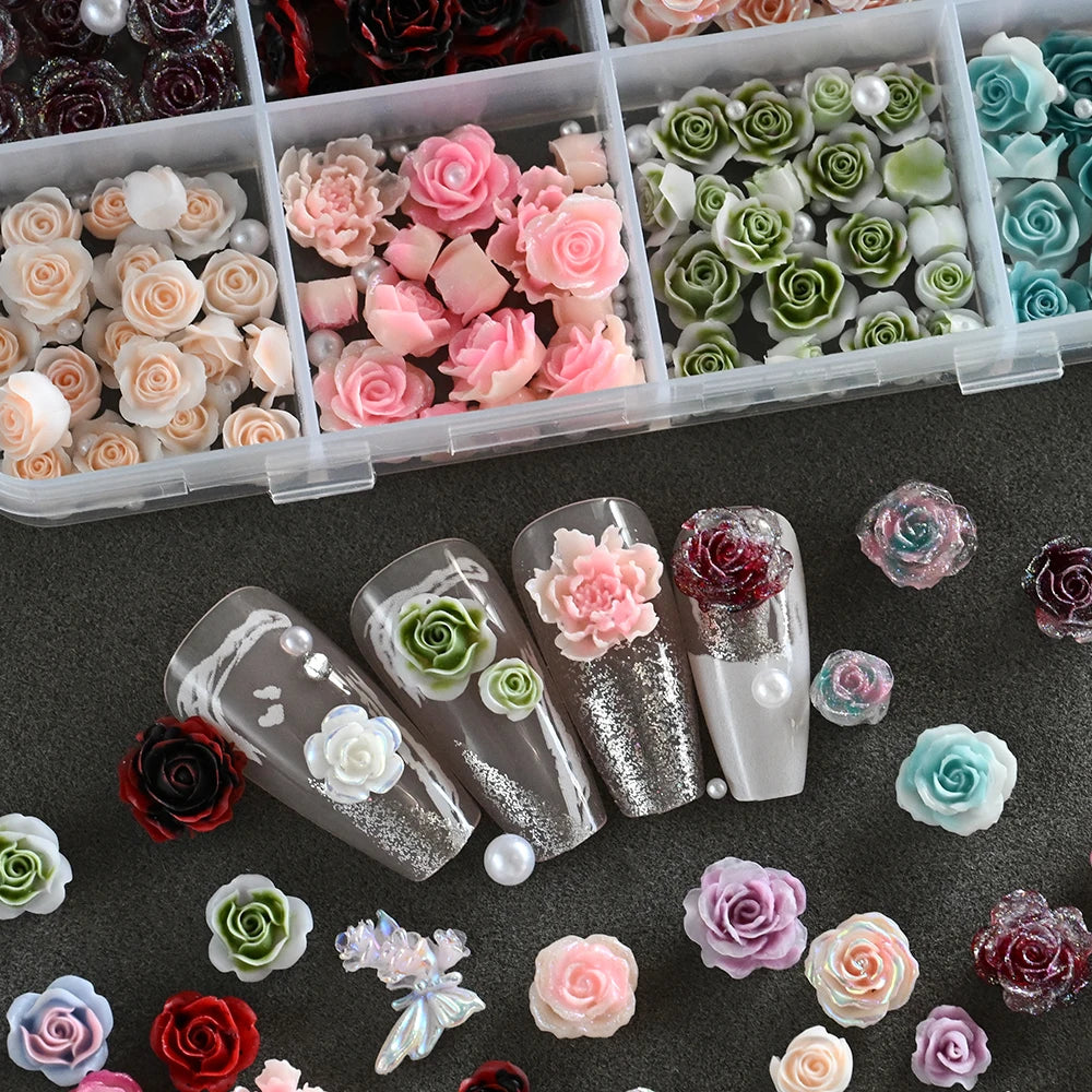 A collection of 3D floral butterfly pearl nail art charms in various shades of pink, green, and red.