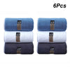 Six thick microfiber cleaning towels in shades of blue and gray stacked side by side.