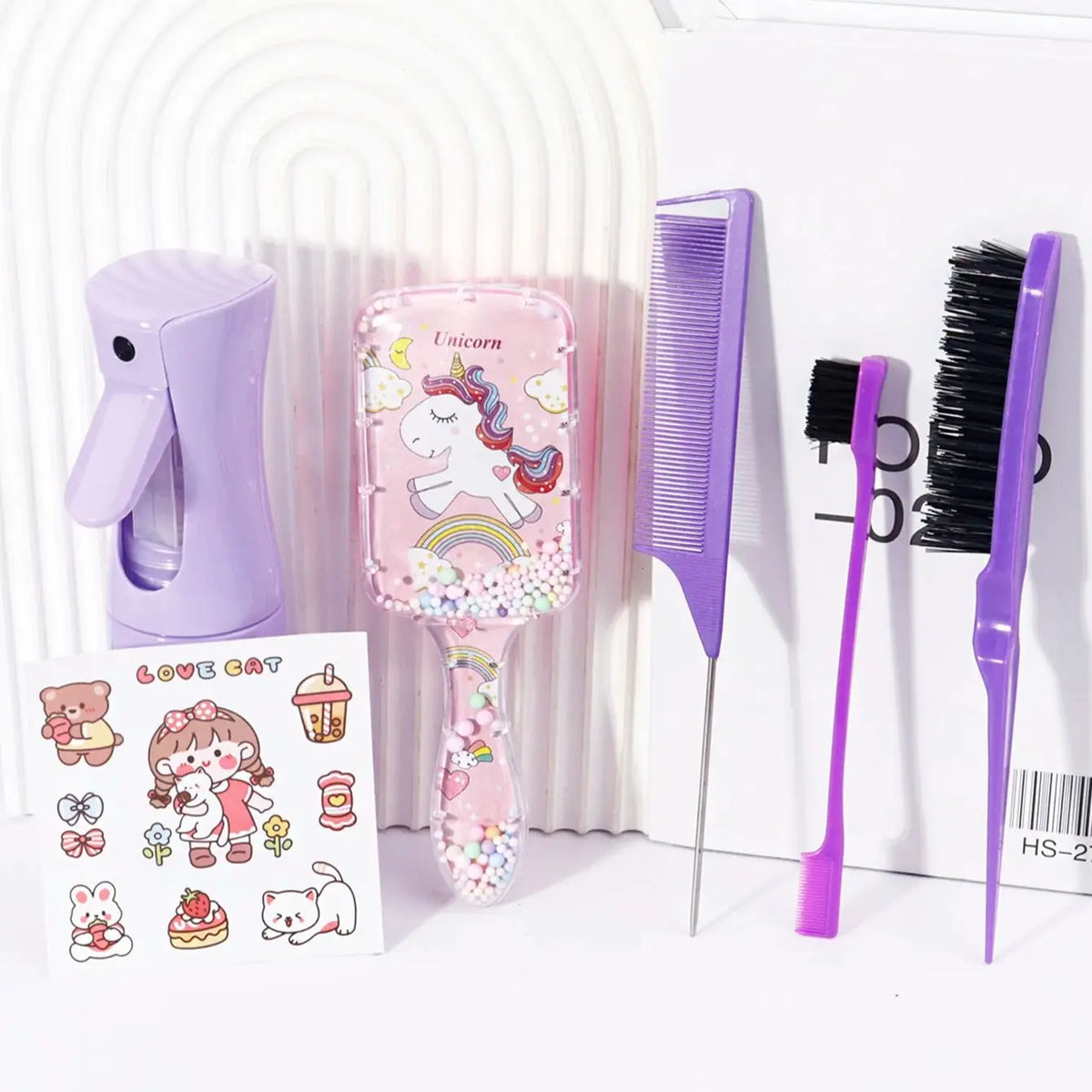 A set of five purple hair styling tools including a hair dryer, a unicorn-themed brush, a wide-toothed comb, and a black brus