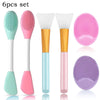 A set of six silicone facial cleansing brushes and applicators in various colors including green, pink, and purple.