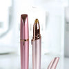 A pink electric eyebrow trimmer and epilator tool shown standing upright on a white surface.