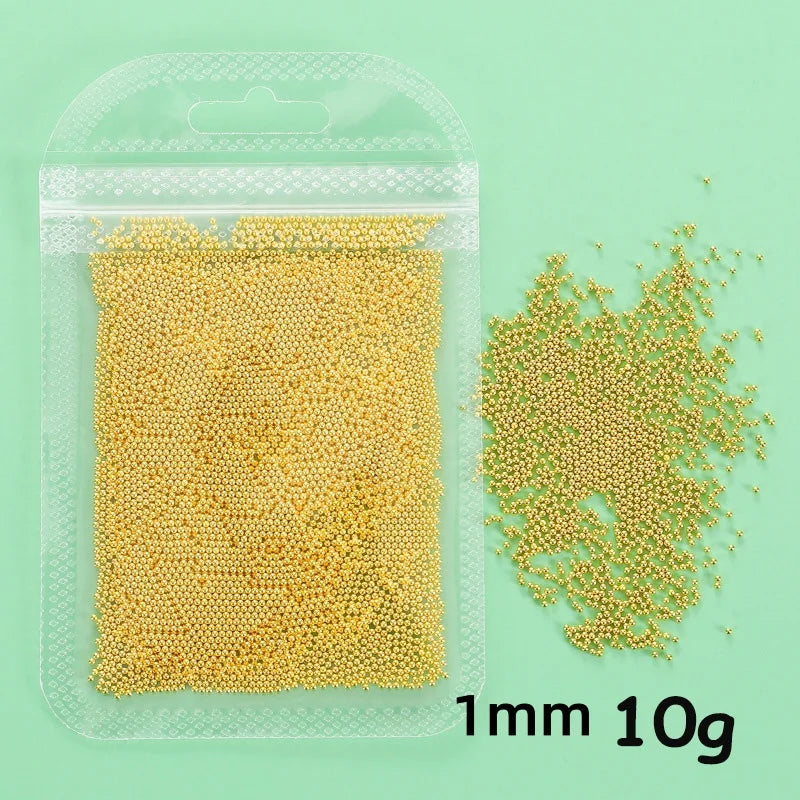 A clear plastic package containing 10 grams of gold mixed stainless steel bead nail art decorations.