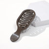 A brown mini travel hair brush with flexible bristles is shown next to its white packaging box.