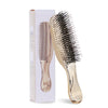 A gold-colored Japanese-style scalp massage brush comb for hair styling and relaxation shown next to its packaging box.