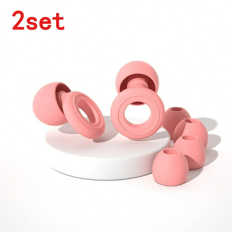 A set of pink silicone ear plugs, including various sizes and shapes, displayed on a white surface.