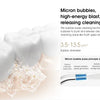 A white electric oral irrigator is shown spraying micro bubbles onto a tooth surface.