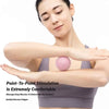 A woman demonstrates point-to-point stimulation on her arm using a pink massage ball for muscle soreness relief.