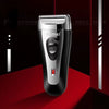 A silver and black Kemei electric shaver is shown against a dark red background.