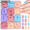 A collection of 288 press-on nails in various shades of pink, green, and purple displayed on a clear plastic tray.