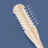 A close-up view of a beige hair trimmer with rotating attachments and multiple teeth, showing the cutting mechanism.