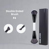 A black double-ended F4 makeup brush shown next to its packaging box.